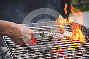 Barbecue hot grilled meat with fire flame heat bbq cooking dinner burn from charcoal. Roast steak grilling with fire and smoking