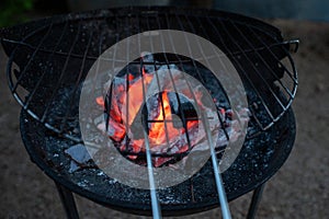 Barbecue lit with charcoal in summer photo