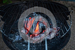 Barbecue lit with charcoal in summer photo