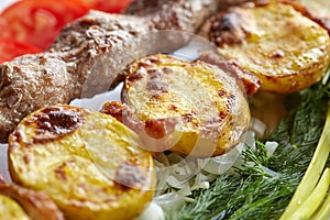 Barbecue Lula Kebab with minced meat, fresh vegetables and greens