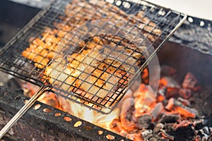 Barbecue meat cooking on fire - the ingredient of bun cha the famous Vietnamese noodle soup with bbq meat, spring roll, vermicelli