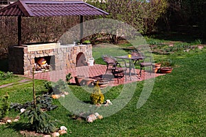 Barbecue Patio Area in Backyard.Gren Grass, Red Brick.