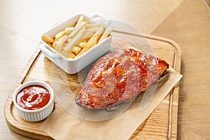 Barbecue pork spare rib. Grilled pork baby ribs with spicy bbq sauce served with french fries.