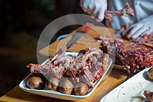 Barbecue is prepared of lamb or sheep meat and processed by slasher. Antrikot and potato kebabs are in a white plate. Roasted meat photo