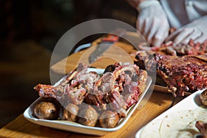 Barbecue is prepared of lamb or sheep meat and processed by slasher. Antrikot and potato kebabs are in a white plate. Roasted meat photo