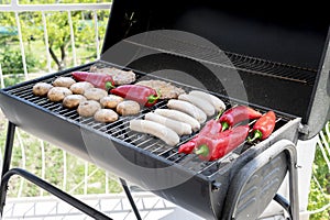 Barbecue with raw vegetables and meat. BBQ on the terrace