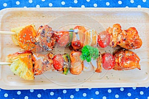 Barbecue ready to serve on wooden tray.