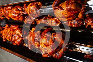 Barbecue roast Chicken in a row turning at industrial roaster