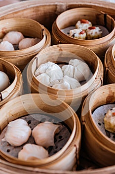 Barbecued pork buns served in steamer baskets with many kind of Dim sum photo