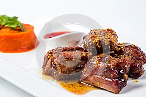 Barbecued pork ribs served with tomato sauce and