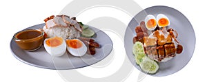 Barbecued red pork, crispy pork belly, boiled egg with rice and red sauce served with cucumber slices