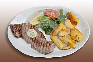 Barbecued rump steak with herb butter,fried potatoes