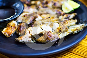 Barbecued salmon fish head on a plate