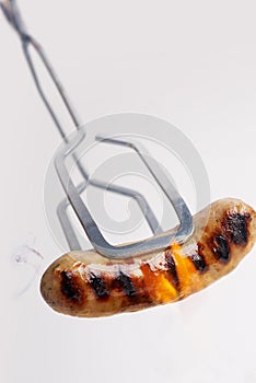 Barbecued sausage and flames