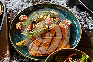 Barbecued sweet potato slices with salad