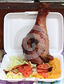 Barbecued turkey drumstick with rice and salad