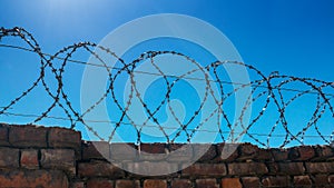 Barbed steel wire on a stone fence