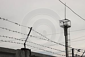 Barbed wire against the cloudy sky