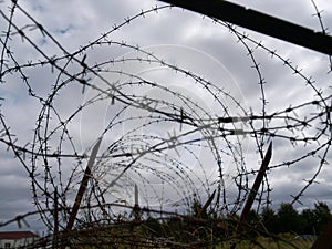 Barbed wire against a menacing sky