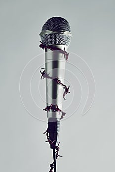 Barbed wire around a microphone