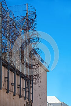 Barbed wire atop a prison wall