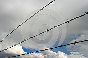 Barbed Wire and Cloud Filled Sky