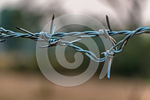 Barbed wire on concrete fence with Twilight sky to feel worrying