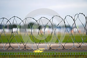 Barbed wire fence around the airport area, security barrier, closeup
