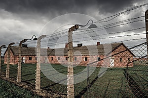 Barbed wire fence and buildings at Auschwitz II - Birkenau, former German Nazi Concentration and Extermination Camp - Poland