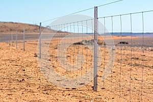 Barbed wire fence on dry land at west Australia