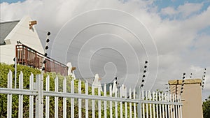 Barbed wire fence. Panning shot of electric fence on a high wall.