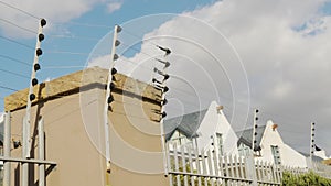 Barbed wire fence. Panning shot of electric fence on a high wall.