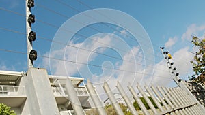 Barbed wire fence. Panning shot of electric fence on a high wall.