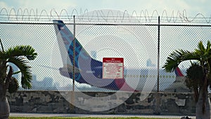 Barbed wire fence surrounding Miami airport runway as protective security measure against trespassing violation. Safety