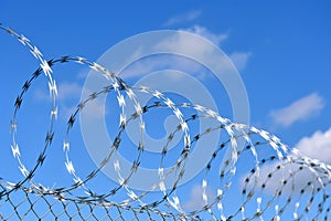 Barbed wire installation enhances security on top of durable concrete fence wall photo