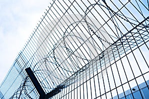 Barbed wire mesh fence. Close-up. Passage is limited