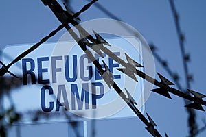 Barbed wire and note on a refugee camp