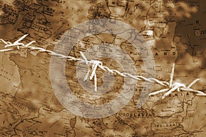 Barbed wire over map of Europe sepia