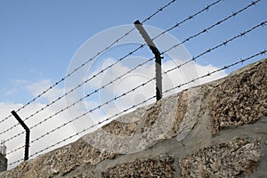 Barbed wire over the stone wall