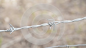 Barbed wire. Part of guarding farm fence. A close up of a barbed wire fence at a cattle farm, protecting private property