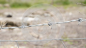 Barbed wire. Part of guarding farm fence. A close up of a barbed wire fence at a cattle farm, protecting private property