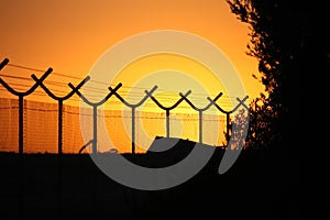 Barbed wire perimeter fence