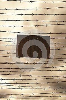Barbed wire and prohibition sign as symbol for freedom or prison