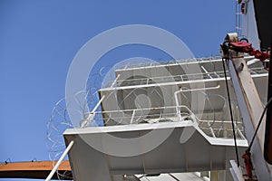 Barbed wire or razor wire attached to the ship superstructure, hull and railings from main deck to  navigational bridge