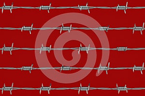 Barbed wire on red background