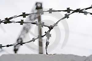 Barbed wire silhouette against cloudy sky