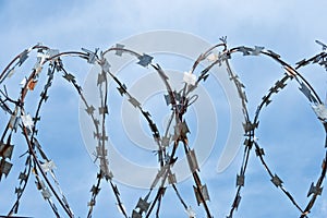 Barbed wire on the sky background