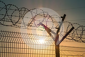 Barbed wire steel fence against the immigration in europe. Restricted area.