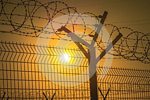 Barbed wire steel fence against the immigration in europe. Restricted area.