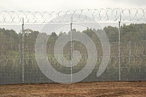 Barbed wire steel wall against the immigrations in Europe photo
